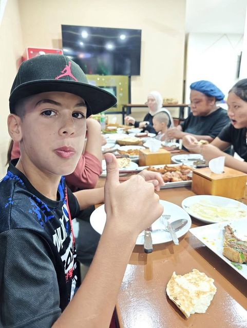 A child enjoying dinner with family at Jerusalem Restaurant Patong